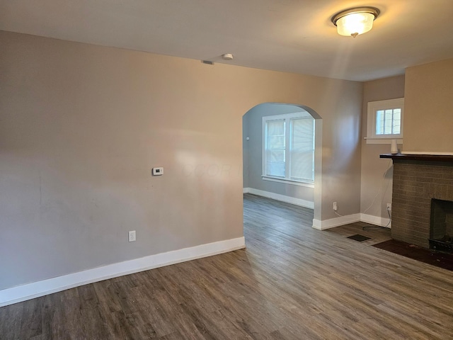 unfurnished living room featuring a fireplace and hardwood / wood-style flooring