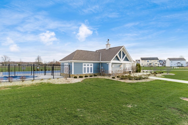 view of front of house with a front lawn and a covered pool