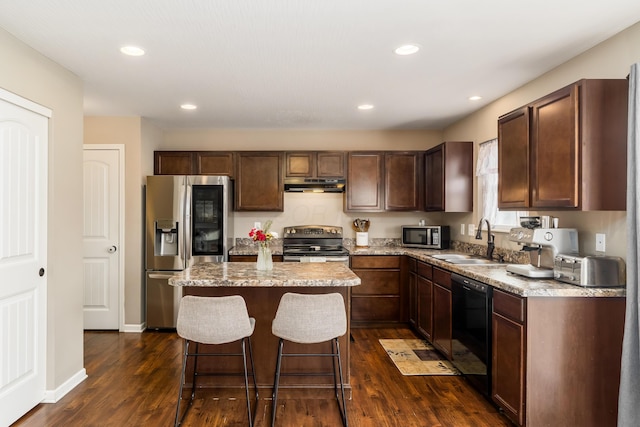 kitchen featuring appliances with stainless steel finishes, dark hardwood / wood-style flooring, sink, and a kitchen island