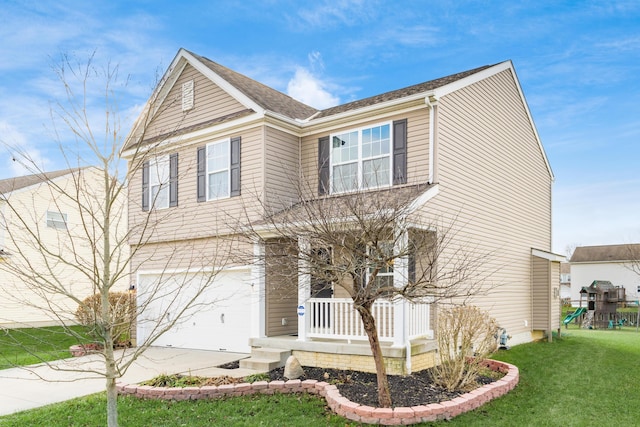 view of front facade featuring a garage, a front yard, and covered porch