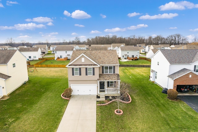 view of front of property featuring a garage, covered porch, and a front lawn