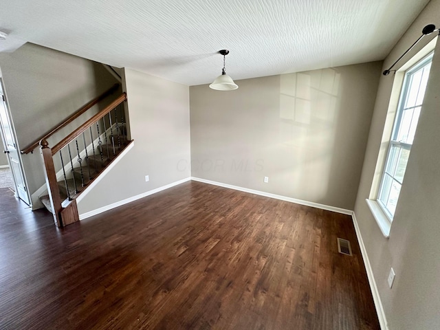 interior space with dark hardwood / wood-style flooring and a wealth of natural light