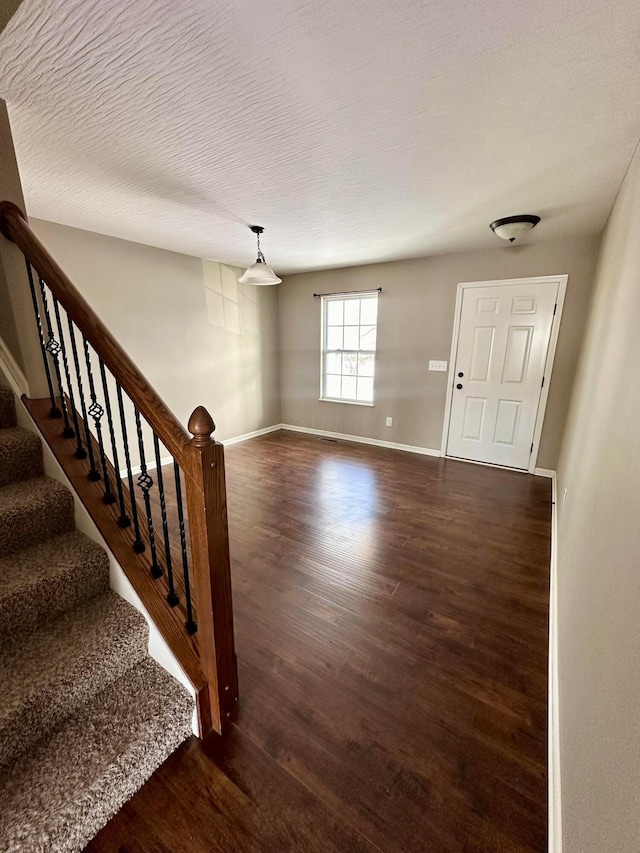 foyer entrance featuring dark hardwood / wood-style floors