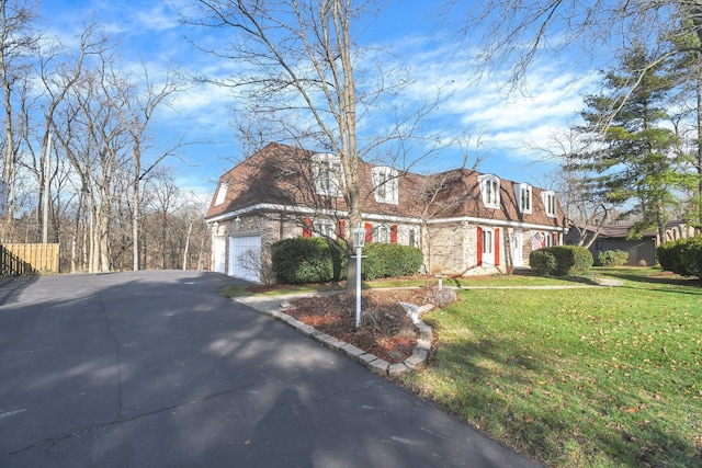 view of front of property with a garage and a front yard