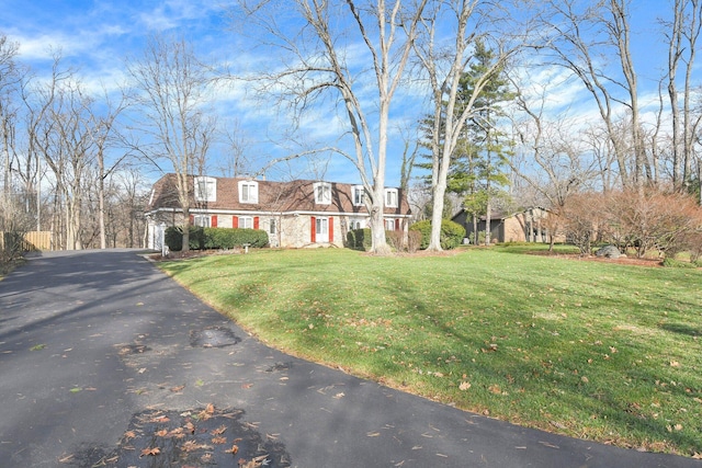 cape cod home featuring a front yard