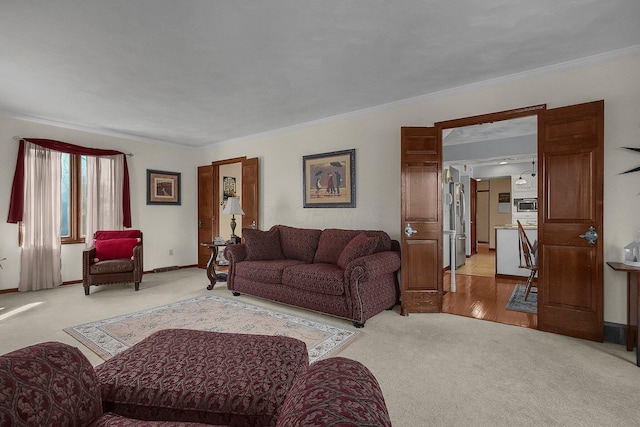 carpeted living room with ornamental molding