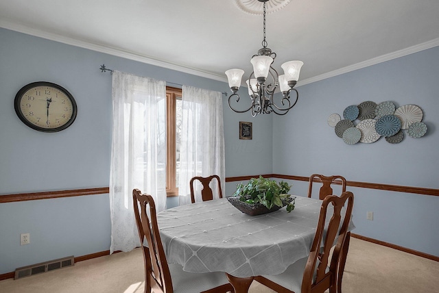 dining room featuring crown molding, light colored carpet, and a chandelier