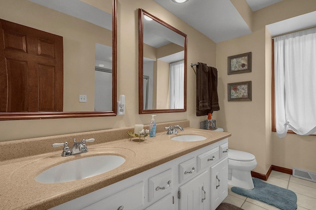 bathroom featuring tile patterned floors, toilet, and vanity