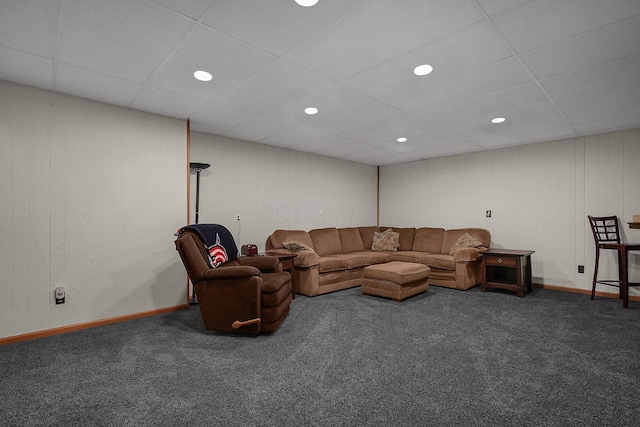 carpeted living room with a paneled ceiling