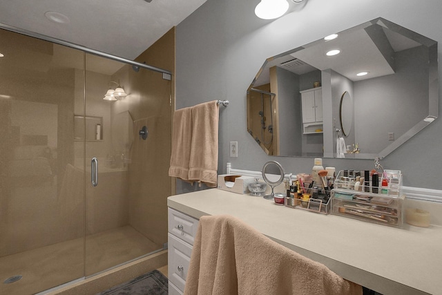 bathroom featuring vanity and a shower with door