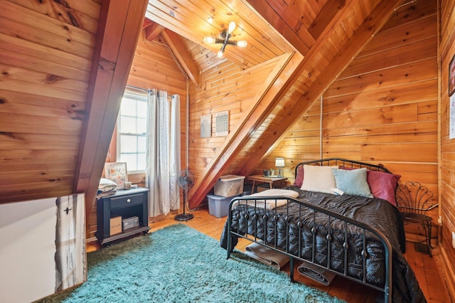 bedroom featuring lofted ceiling with beams, wooden ceiling, hardwood / wood-style flooring, and wooden walls