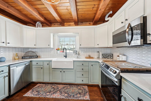 kitchen featuring beamed ceiling, wooden ceiling, stainless steel appliances, and dark wood-type flooring