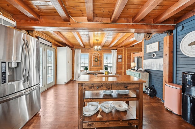 kitchen with stainless steel fridge, dark hardwood / wood-style flooring, wood ceiling, beam ceiling, and wood walls