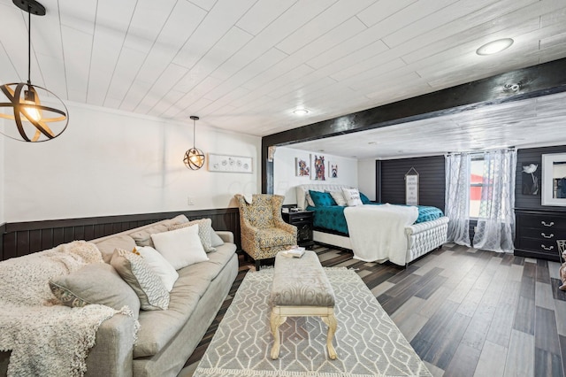 bedroom with beamed ceiling, dark hardwood / wood-style floors, wood walls, and wood ceiling