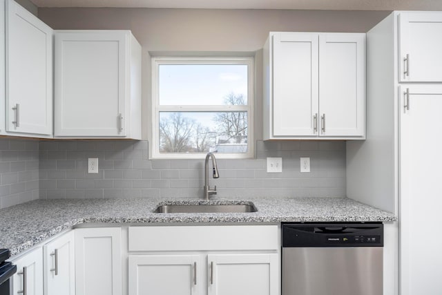 kitchen featuring dishwasher, decorative backsplash, white cabinets, and sink