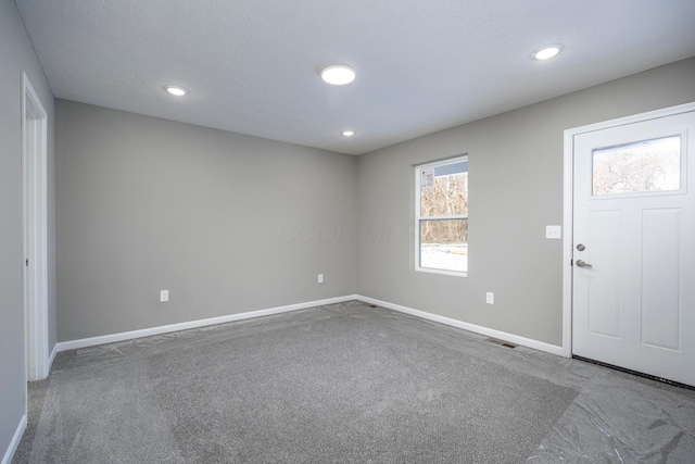 foyer entrance featuring carpet floors