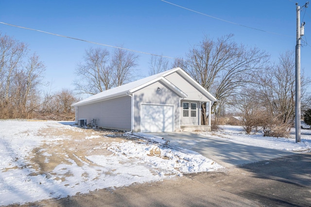 exterior space featuring a garage and central air condition unit