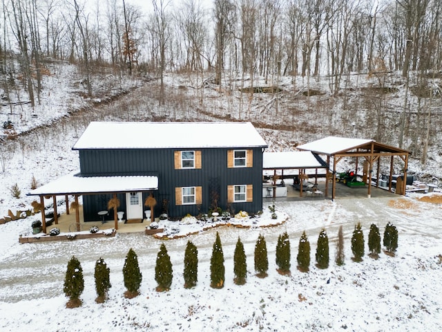 snow covered property with an outdoor structure