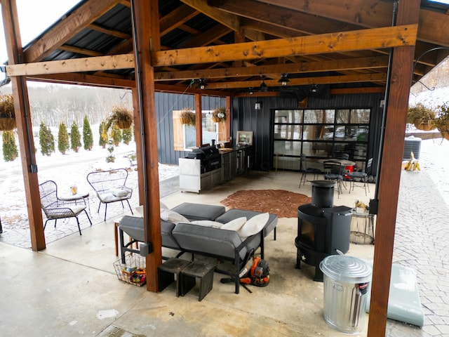 snow covered patio with a gazebo and grilling area