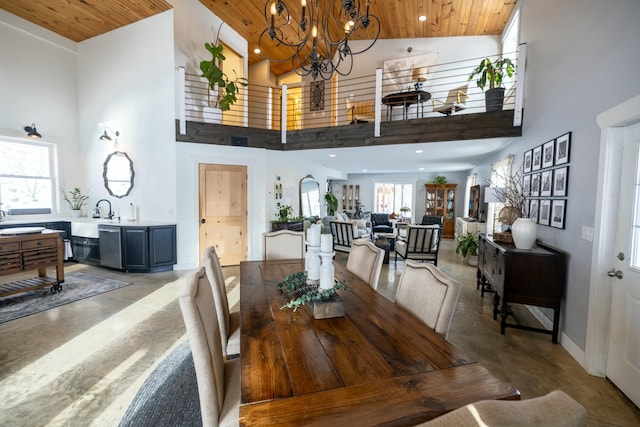 dining room with a chandelier, concrete floors, high vaulted ceiling, and wooden ceiling