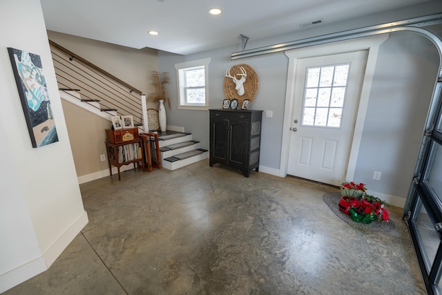 entrance foyer featuring plenty of natural light and concrete flooring