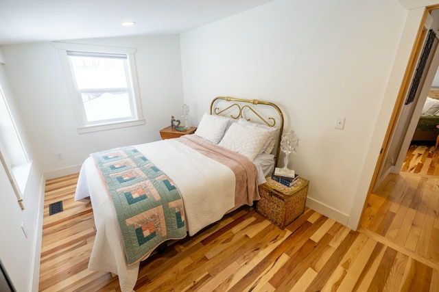 bedroom with hardwood / wood-style floors