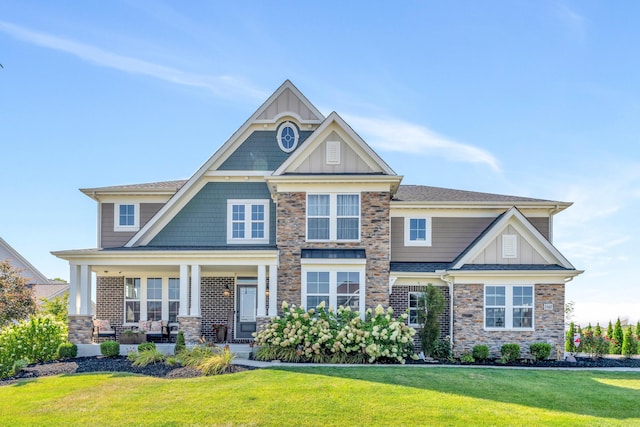 craftsman house with a front lawn and a porch