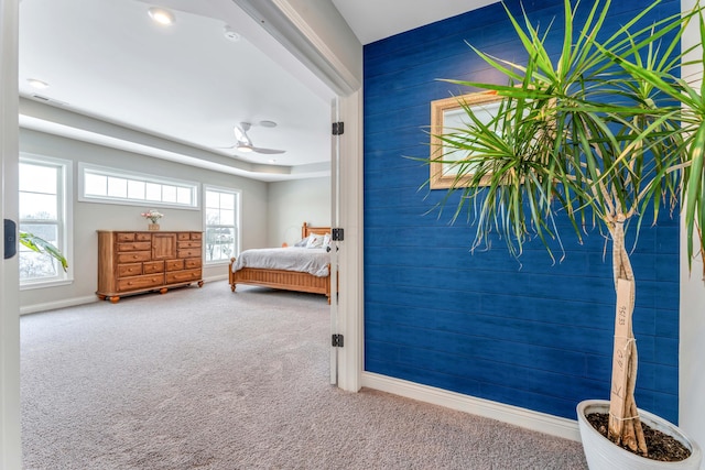 bedroom featuring multiple windows and carpet