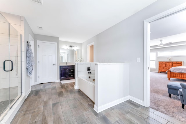 hall with sink and light colored carpet