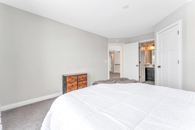 carpeted bedroom with ensuite bath