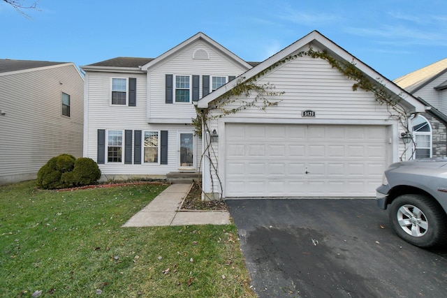 view of front of home with a garage and a front lawn