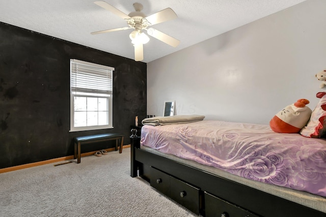 carpeted bedroom with ceiling fan and a textured ceiling