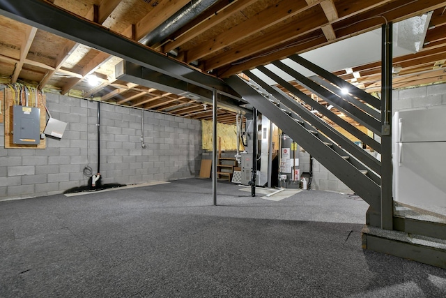 basement with electric panel, gas water heater, and heating unit