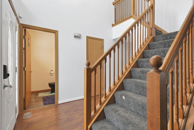 stairs featuring hardwood / wood-style floors