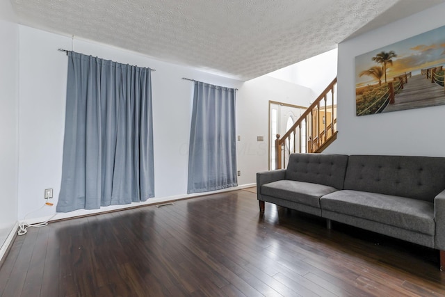 living room featuring hardwood / wood-style flooring and a textured ceiling