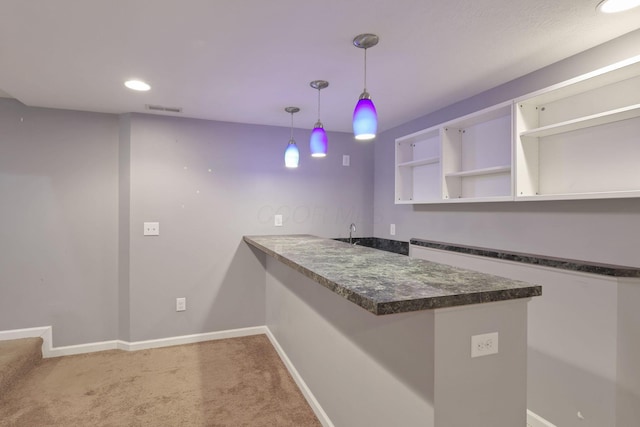 bar featuring carpet flooring, decorative light fixtures, white cabinetry, and built in shelves