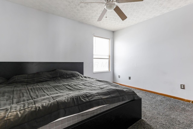 carpeted bedroom with ceiling fan and a textured ceiling