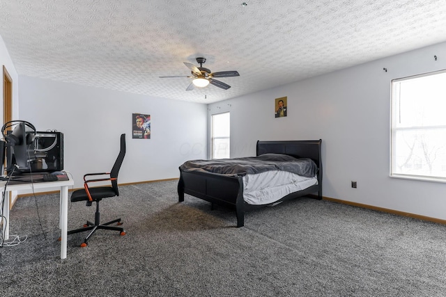 bedroom featuring ceiling fan, carpet floors, and a textured ceiling