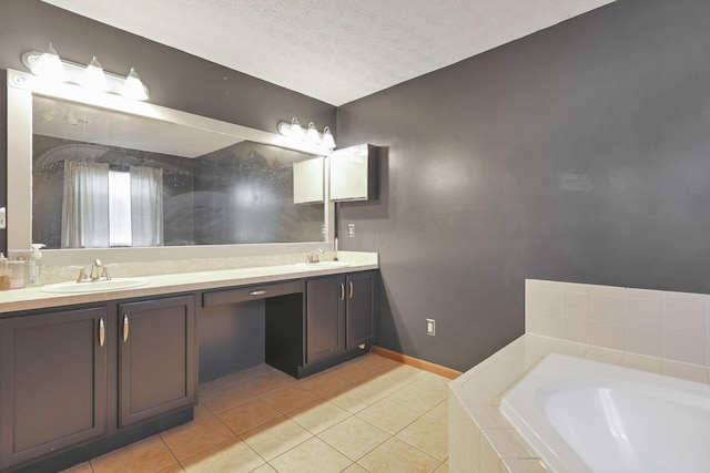 bathroom featuring tiled bath, tile patterned flooring, vanity, and a textured ceiling