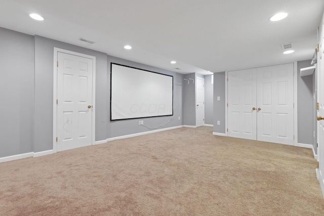 home theater with light colored carpet