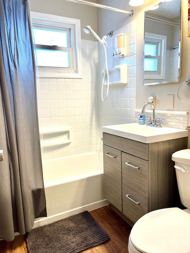 full bathroom featuring vanity, toilet, wood-type flooring, and shower / tub combo with curtain