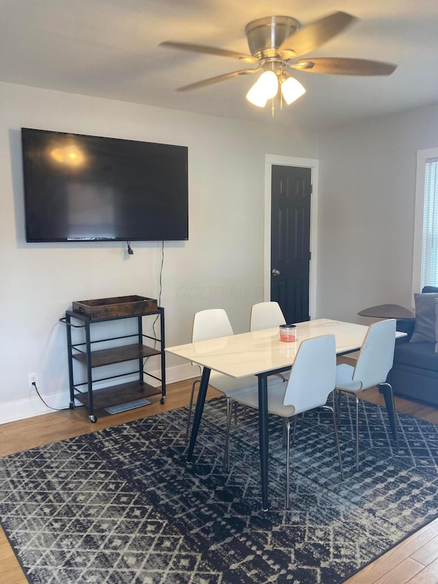 dining room with hardwood / wood-style flooring and ceiling fan