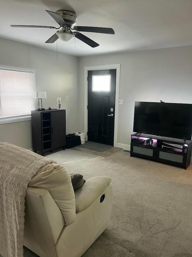 carpeted living room featuring ceiling fan