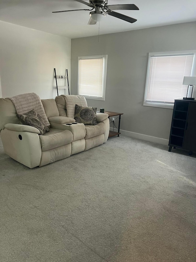 carpeted living room featuring ceiling fan