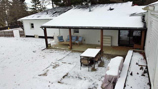 view of snow covered back of property