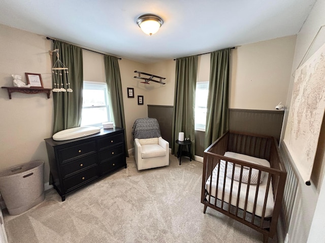 carpeted bedroom with a crib