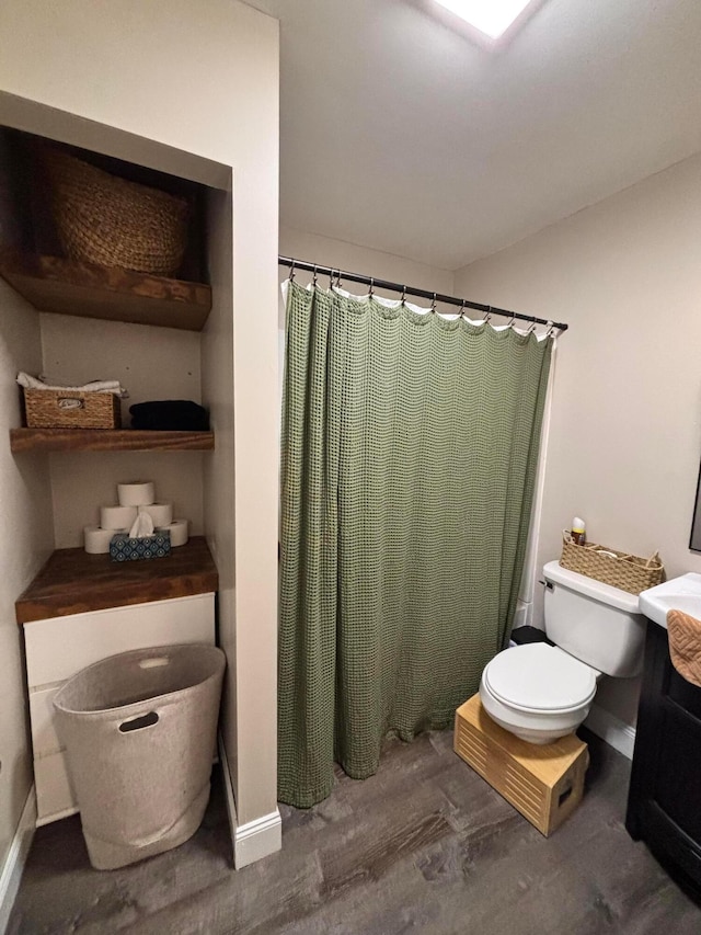 bathroom with curtained shower, vanity, wood-type flooring, and toilet