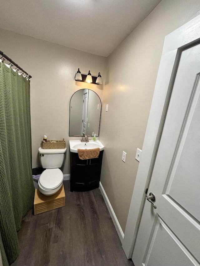 bathroom with hardwood / wood-style floors, vanity, and toilet