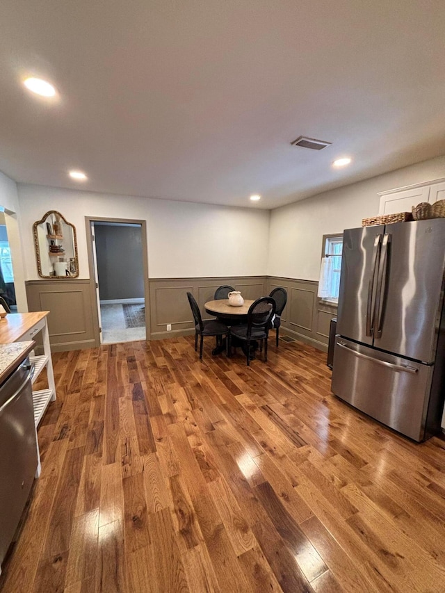 interior space featuring wood-type flooring and appliances with stainless steel finishes