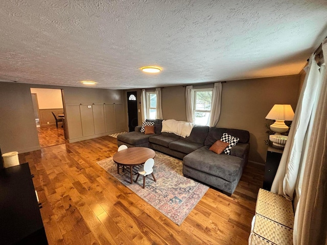 living room with hardwood / wood-style floors and a textured ceiling